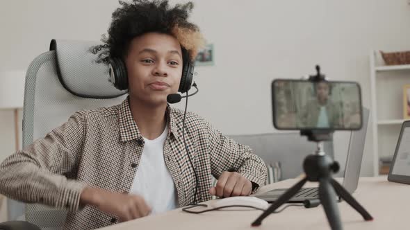 African Boy Recording him on Smartphone alt