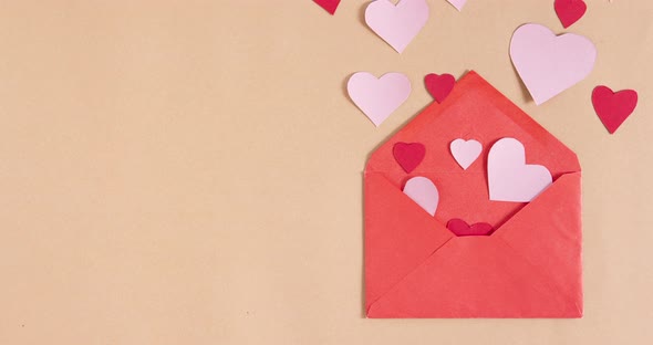 Stop motion animation with hearts getting out of envelope. Copy space