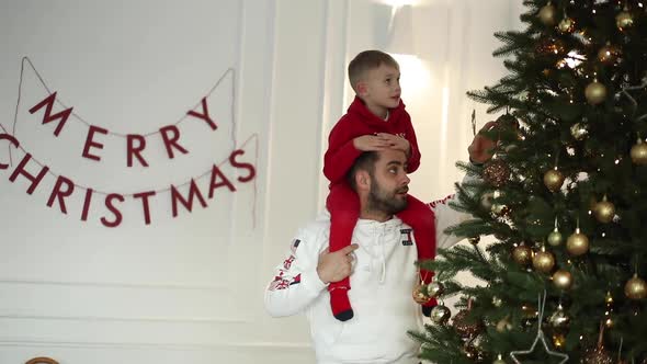 Loving Father with His Son Snuggling on Chair