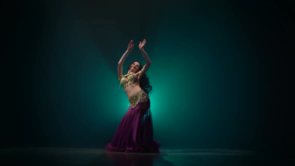 Belly Dancer Girl Shaking Her Hips. Smoke Background alt