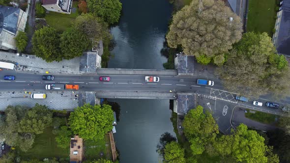 Top down aerial of european town bridge over a significant river. Traffic flows in one direction, wi alt
