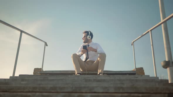 Man Listening To Music In Headphone.Businessman Relaxing After Good News Having Fun Work Break Pause alt