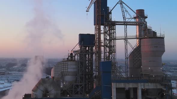 Aerial View of Cement Plant Production Area with High Concrete Factory Structure and Tower Cranes at alt