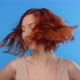 Redhead Pretty Woman Rolls Her Head and Toss Her Hair on the Blue Screen