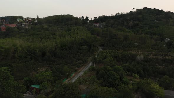 Drone Flight Over the Jungle and Sea City After Sunset alt