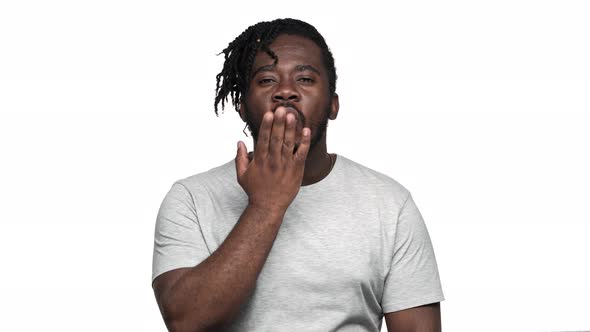 Portrait of Romantic Flirty Afro Man with Stylish Hairdo and Mustache Blowing Air Kiss to you alt