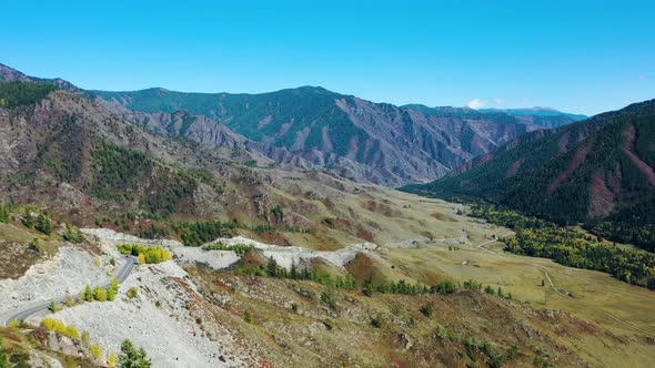 Aerial View Mountain Road in a Sunny Day. Mountain Pass Chike-Taman, Mountain Altai Region, Russia. 