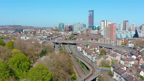 Drone shot towards central croydon national rail train passing through alt