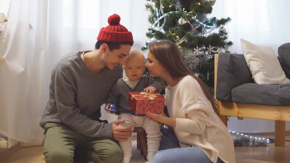 Young Family Opens a Christmas Gift