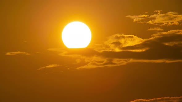 Telephoto lens Close up the sun in sunset Dramatic sky time-lapse 4k. Clouds and Sun Rising Sky alt