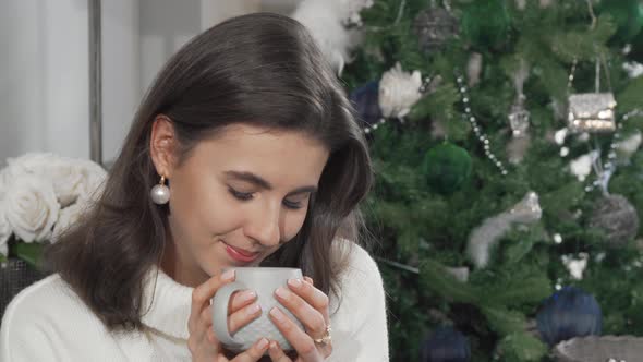 Beautiful Happy Woman Smiling to the Camera While Having Tea at Home alt