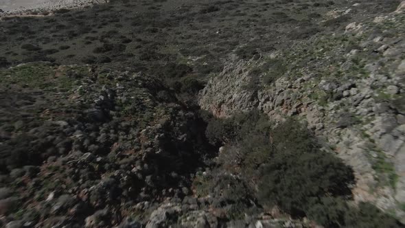 Caucasian woman on Balos beach Crete. Aerial drone first person view alt
