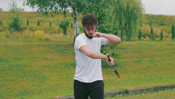 Man Twists Nunchucks alt