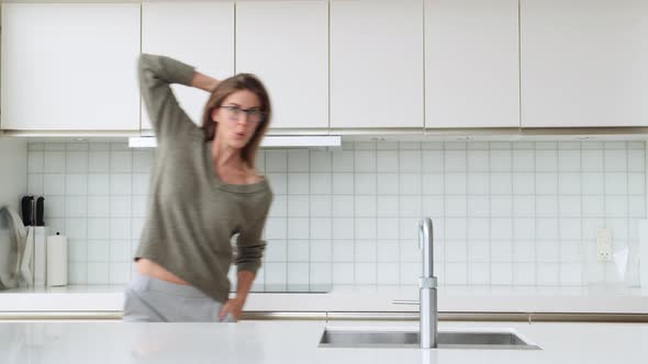 Woman Sliding through Kitchen