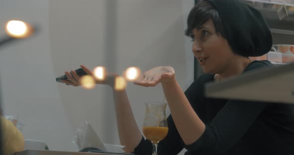 Woman Talking To Friend and Browsing Web on Cellphone alt