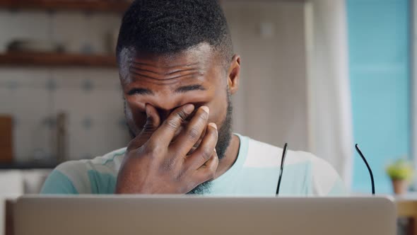 Tired Freelancer with Eyes Hurt Working on Laptop at Home Office alt