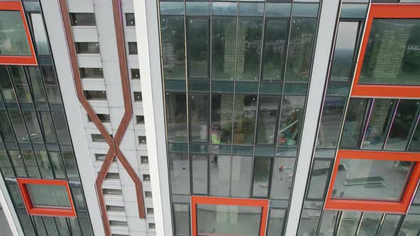 Aerial View of the Exterior of a Modern Hotel Building with Large Windows alt