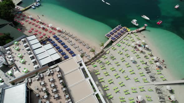 Aerial View Azure Beach with Empty Sun Loungers Balkan Coast Ionian Sea Albania alt