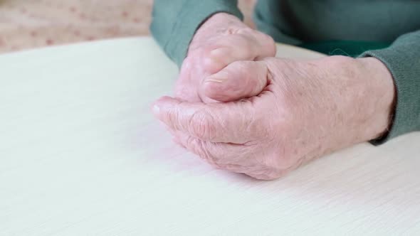 Closeup of the Wrinkled Old Tired Hands of an Elderly Man