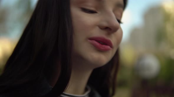 Young Focused Woman Working with Laptop in City Park Sitting on Bench Freelance alt