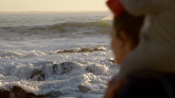 Mother playing with her baby boy in the beach alt