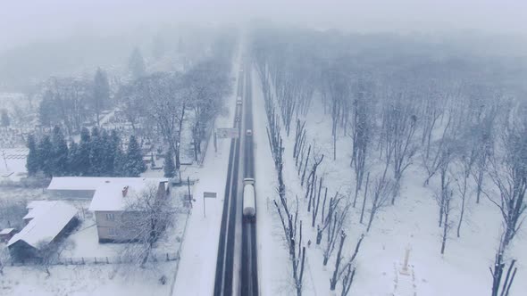 Aerial view of small town in snowfall. Blizzard. Snowstorm.