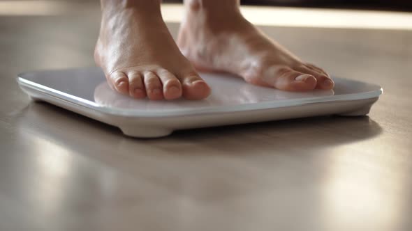 Girl Measuring Weight On Health Scale Weight.Woman On Scale.Scale Weight On Floor.Weighing Scales alt