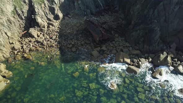 Cargo Shipwreck Of RMS Mulheim In An Island Near Land's End United Kingdom - aerial shot alt