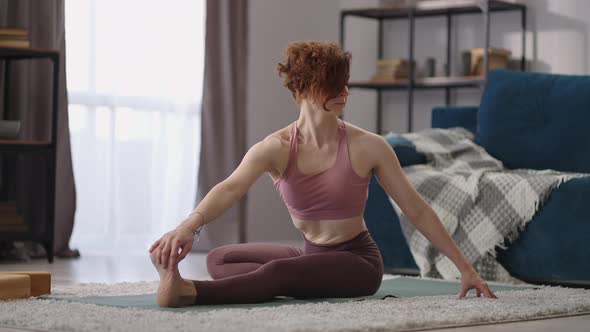 Stretching Training of Adult Woman at Home Female Sportsperson is Sitting on Floor Performing alt