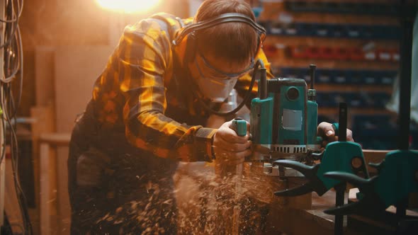 Man Woodworker Polishes the Sides of a Wooden Detail alt