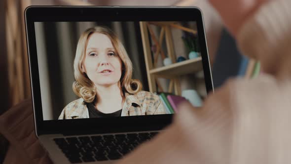 A Woman Communicates with a Friend Via Video Call alt