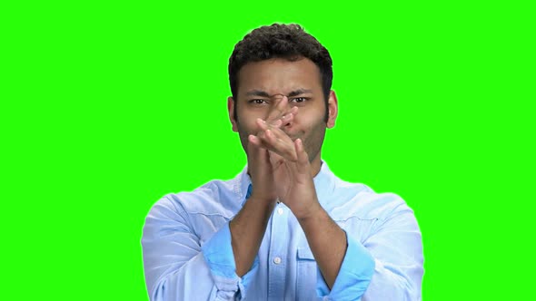 Young Man Making Funny Face on Green Screen alt