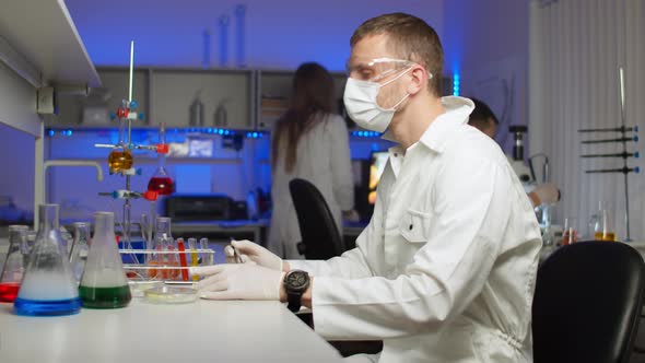 Scientist Examining Sprouts in Petri Dish