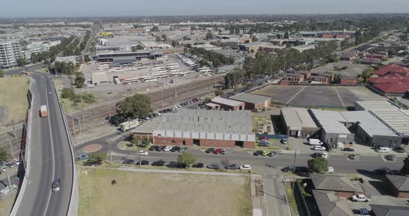 Aerial perspective of Dandenong infrastructure connecting city area to suburbs while truck pulls up alt