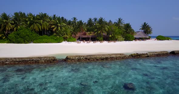 Wide angle birds eye copy space shot of a sandy white paradise beach and turquoise sea background in alt