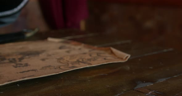 Pirate Captain Takes Wooden Musical Box and Puts on Table alt