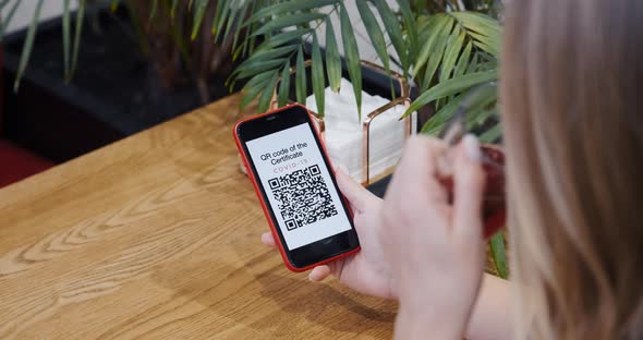 QR Code of Vaccination Certificate on the Screen of Mobile Phone Smartphone alt