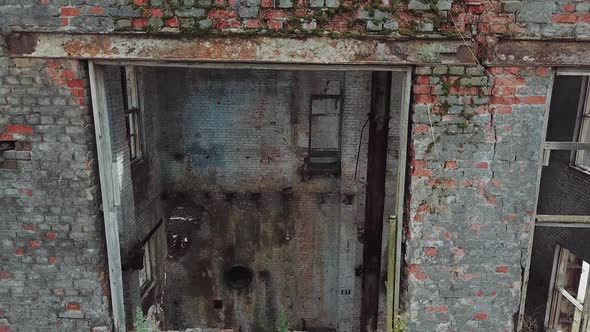 Flight over the destroyed factory. Facade of old industrial building for demolition alt