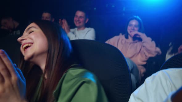 Happy Woman Dancing in Cinema. Cheerful Girl Having Fun in Movie Theater. alt