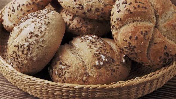 Wicker basket with selection of breads and pastries. Assortment of baked products 