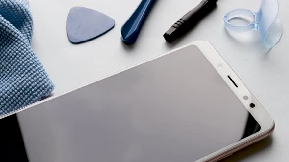 maintenance and repairing smartphones. spin on table many tempered glass screen protectors and mobil alt