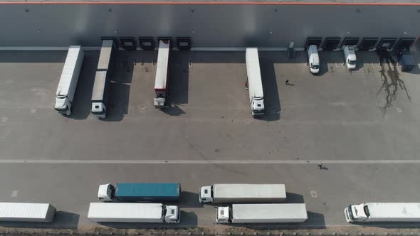Buildings of Logistics Center Warehouses in Field Near the Highway View From Height Trucks in alt