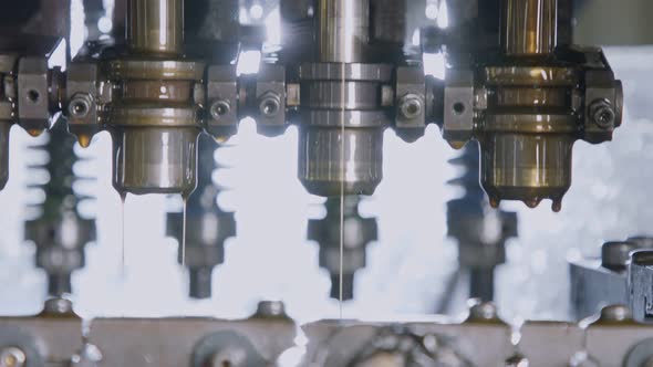 Close up of a punch press forming metal parts in a production line alt