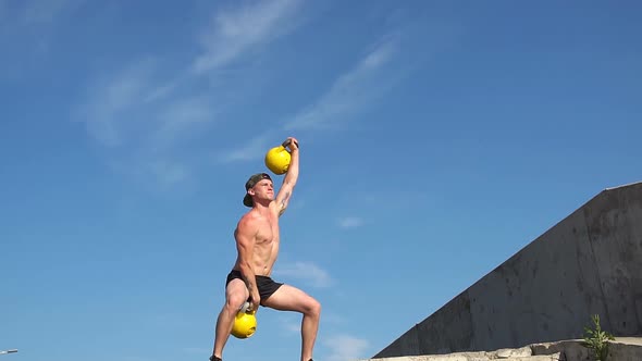 Young Athletic Man Doing Exercise Gorilla Weights Outdoor. Crossfit. Slow Motion