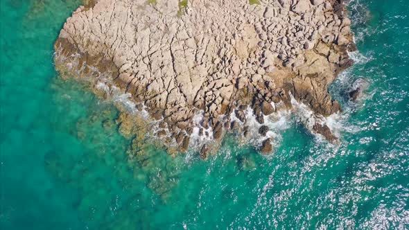 Aerial Top View Of Cliffs Of A Rocky Coast With Turquoise Sea alt