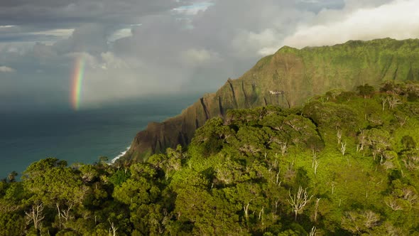 Beautiful Kauai Coastline Arial with Rainbow in Cloudy Sky at Sunset  Footage alt