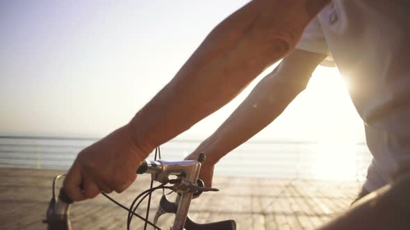 Handsome Senior Man Riding Bike on Seafront Slow Motion Close Up Shot Slow Motion alt