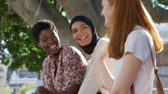 Young adult female friends hanging out together alt