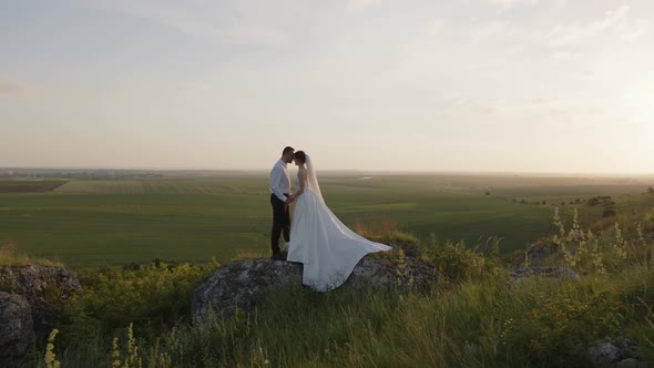 Bride and Groom Hold Their Hands Together alt