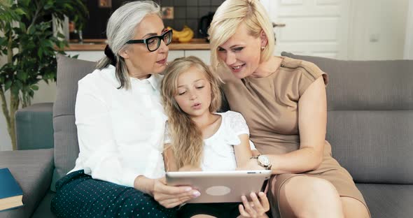 Family with Tablet on Sofa